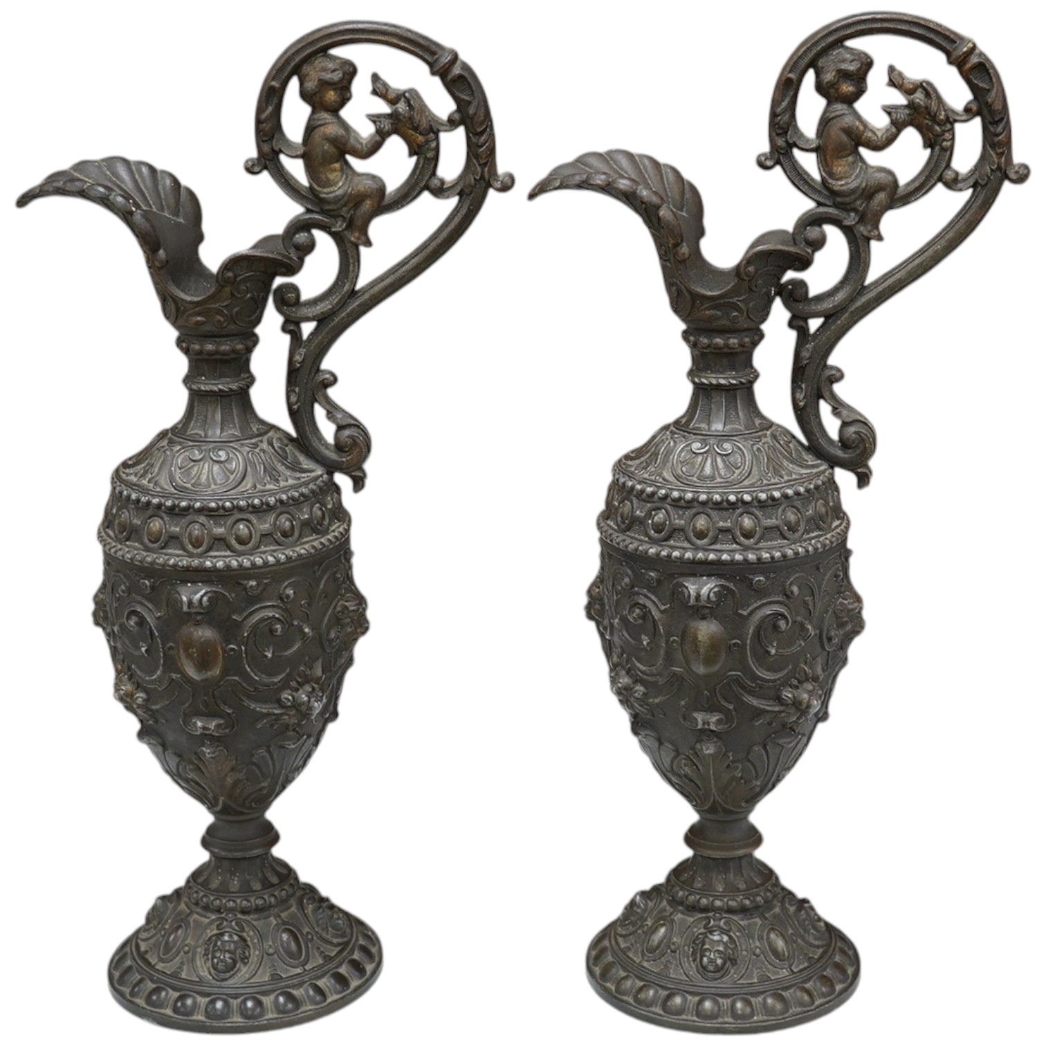 A pair of spelter Cellini ewers, 34.5cm high. Condition - fair to good, some general wear overall